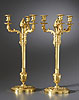 A fine pair of Empire gilt bronze four-light candlesticks